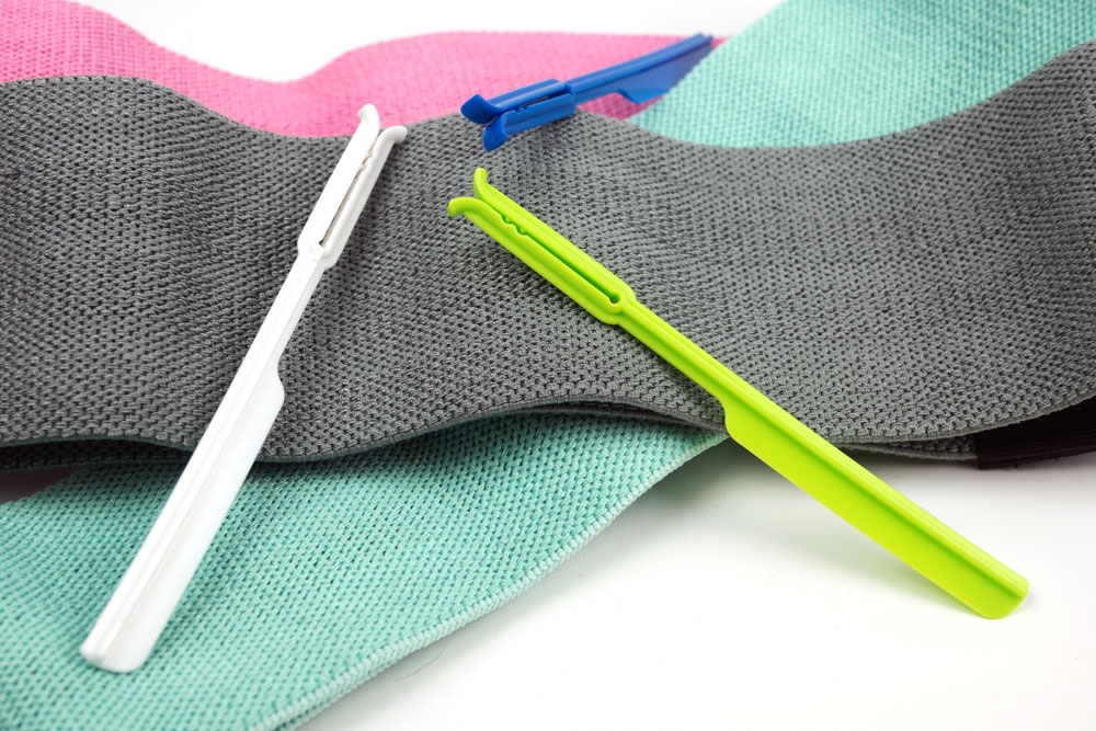 Green, White, and Blue ScoopJacks positioned laying on resistance bands